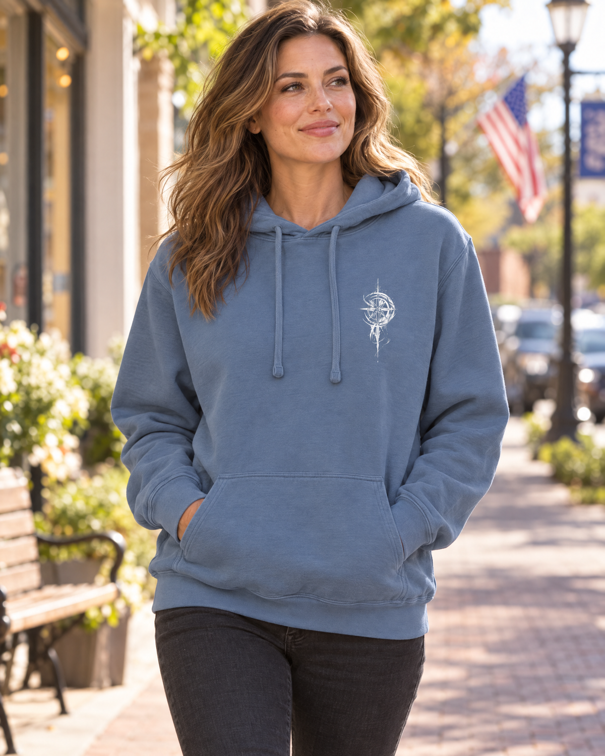 Woman wearing Blue Jean Grit With Faith garment-dyed hoodie with embroidered compass outdoors